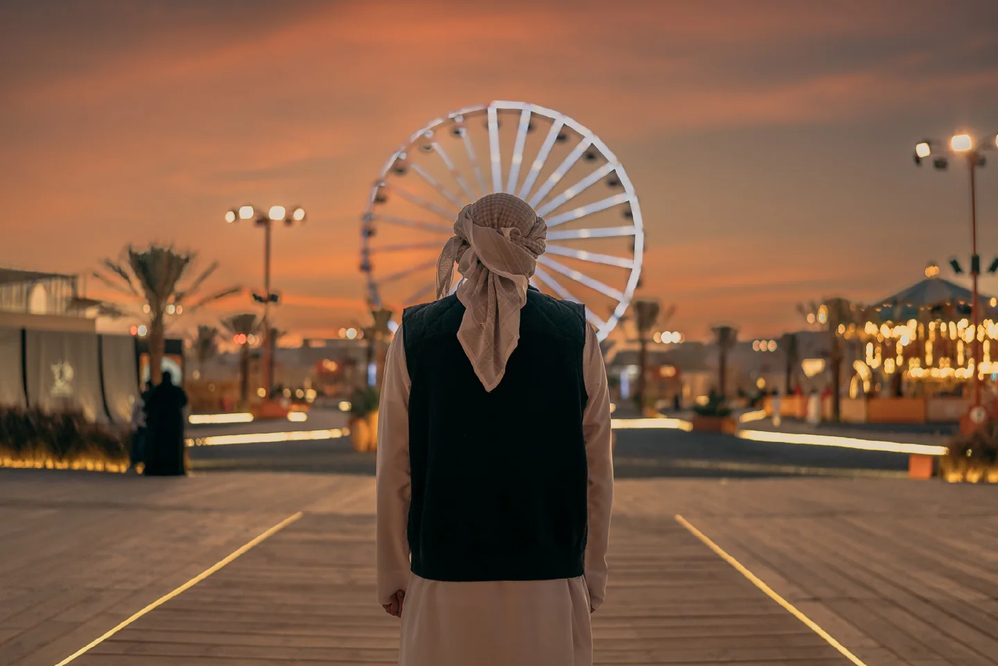 A Ferris wheel and walkway in an archive photograph from Liwa Festival.