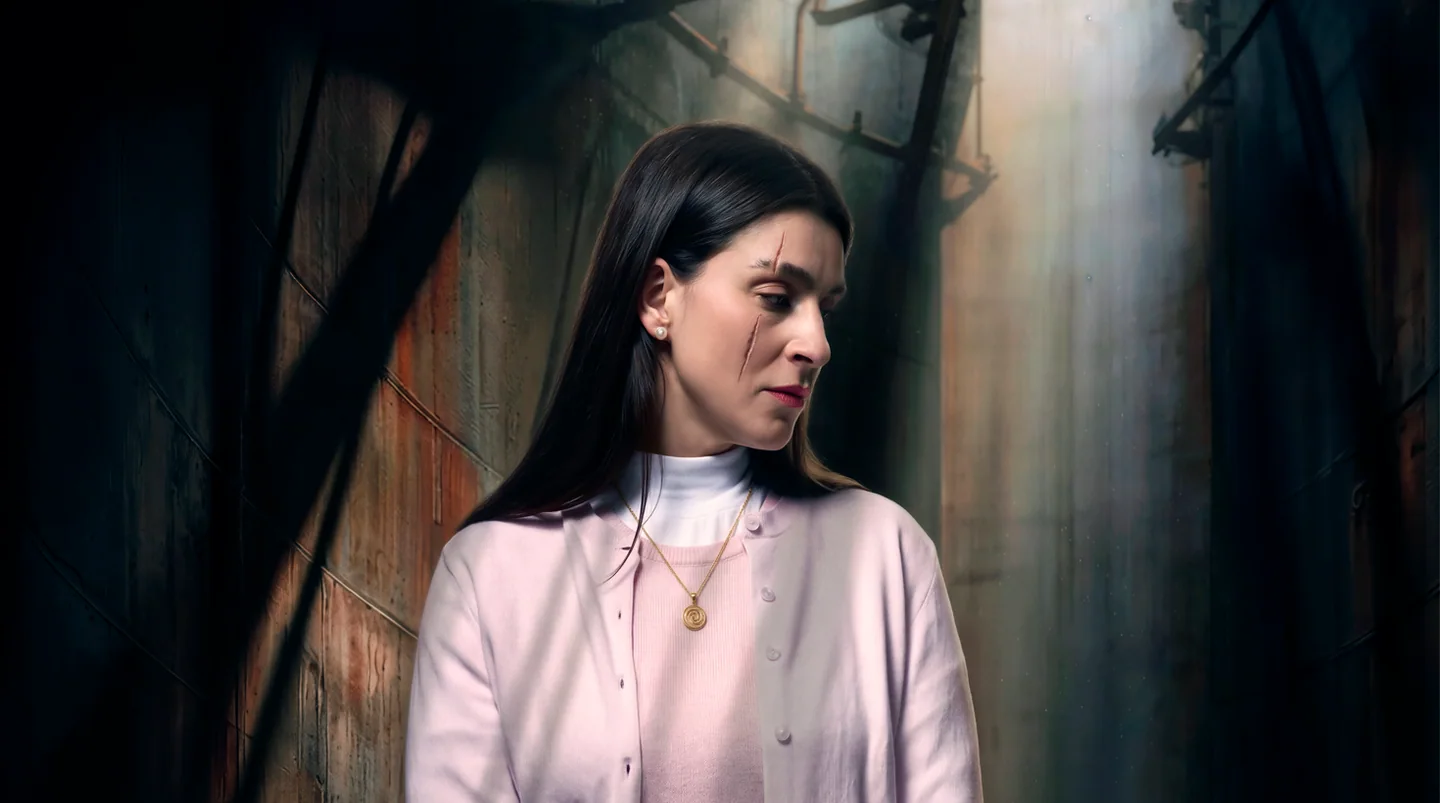 Official Jenůfa artwork: a woman beside a wooden wall.