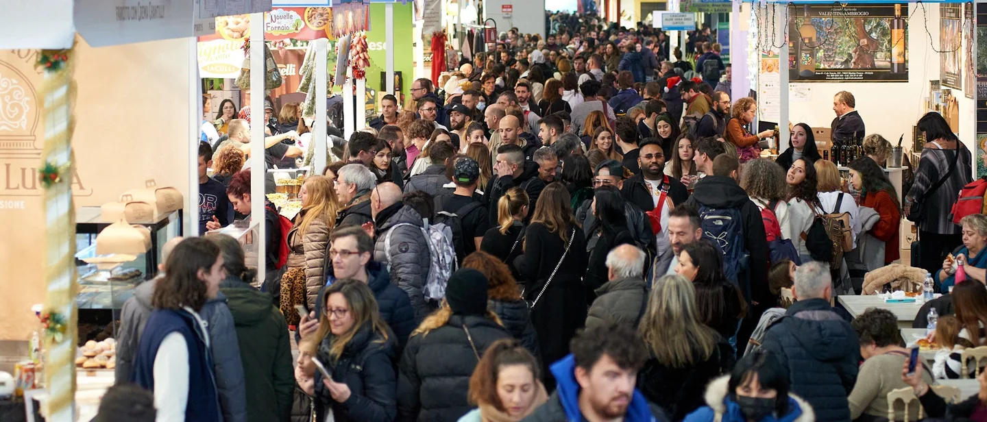 Visitors walk past food and gastronomy stands.
