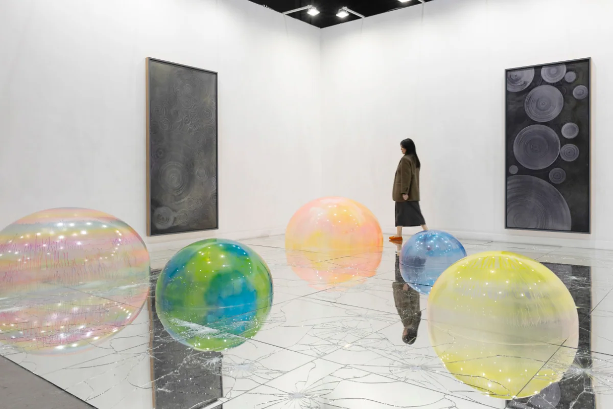 miart 2026 archive: coloured transparent spheres and paintings on a gallery stand.