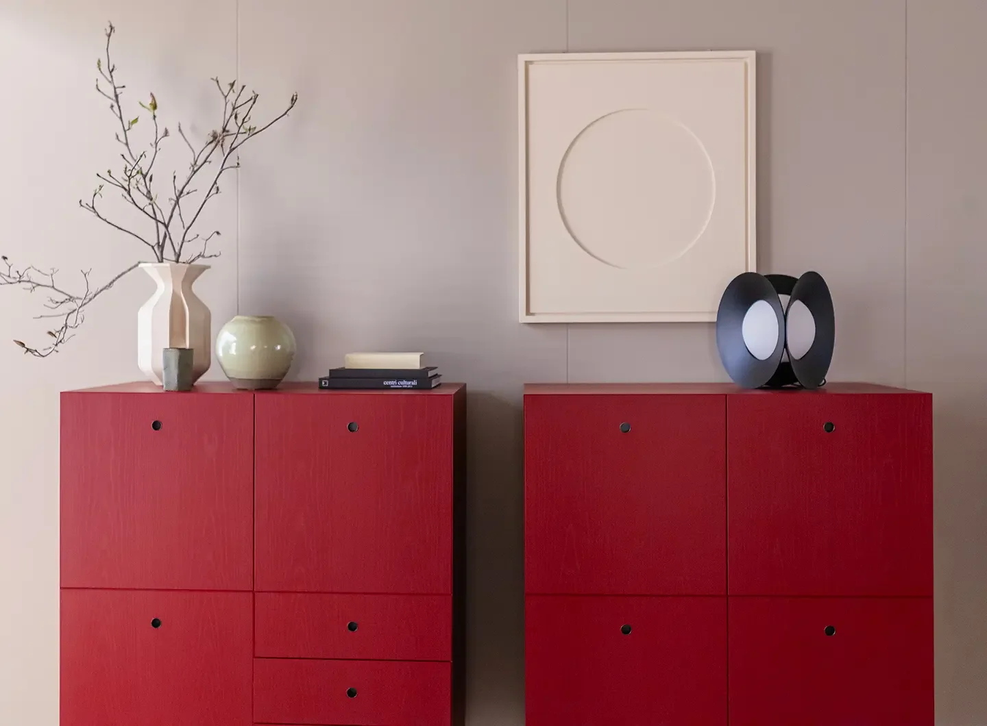Red Porro cabinets and objects on shelves in an exhibition display.