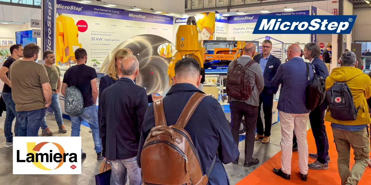Visitors beside equipment at the MicroStep stand.